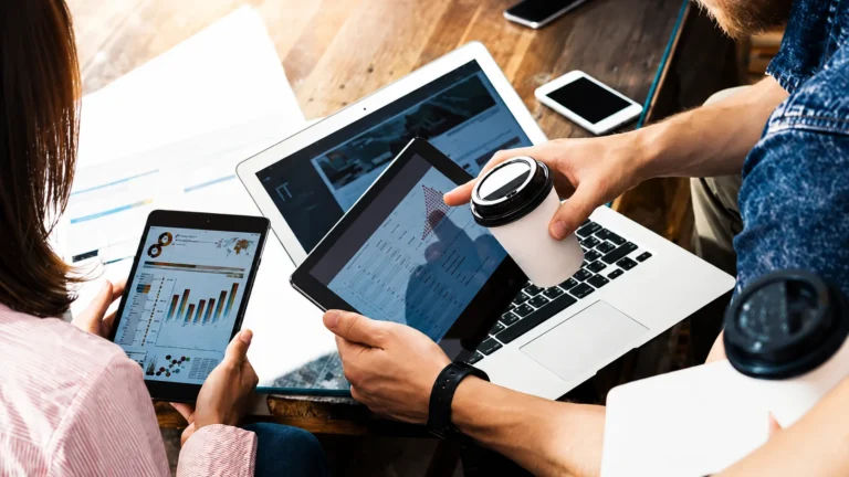 Team analyzing digital marketing data on multiple devices - Digital Marketing Agencies