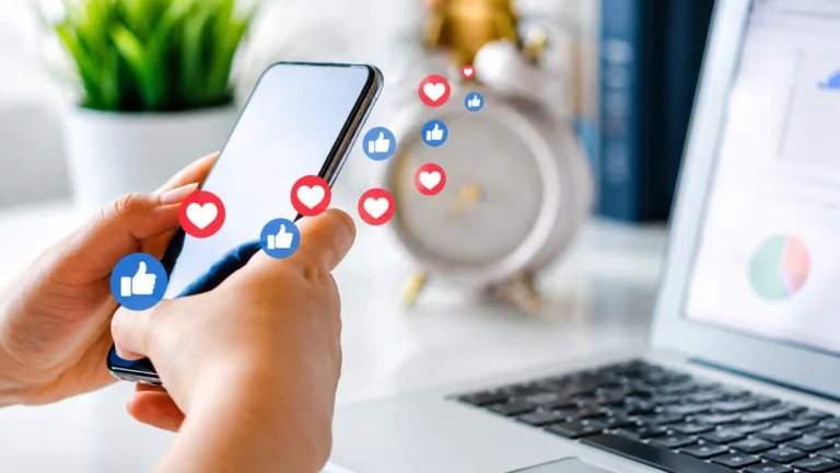 Social media optimisation concept with smartphone, social media like icons, and laptop workspace.