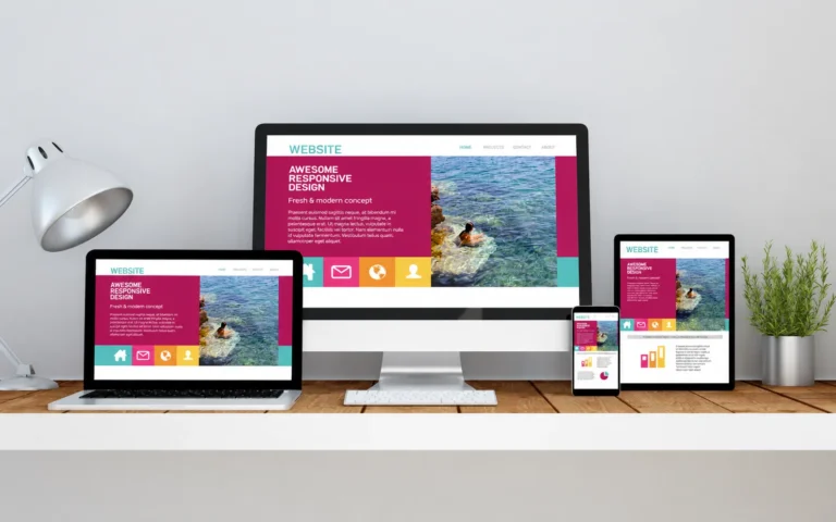 Responsive website creation displayed across desktop, laptop, tablet, and mobile devices on a modern workspace setup.